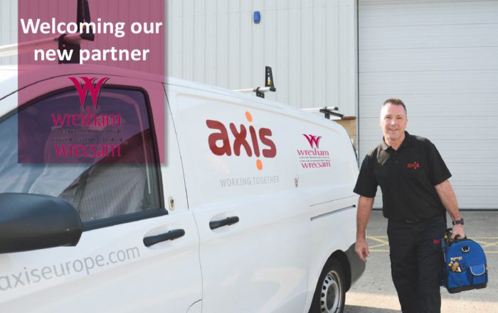 Axis person stood beside dual branded van announcing new contract win with wrexham council