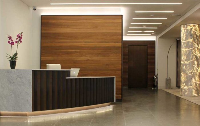 desk chairs and walls in a reception space.