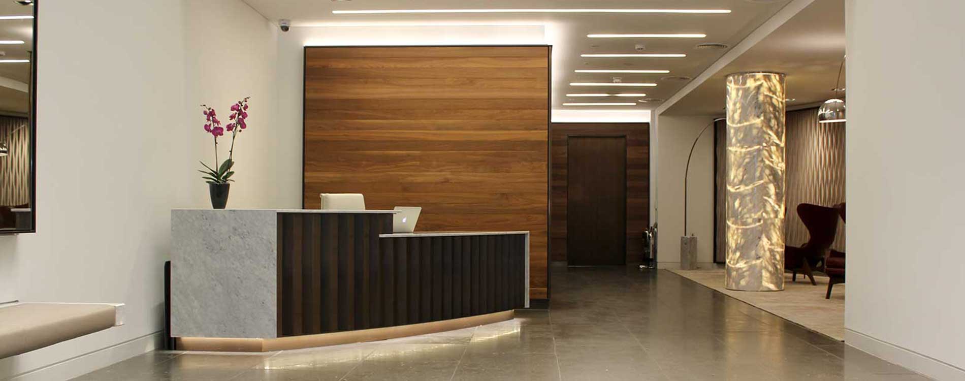 desk chairs and walls in a reception space.