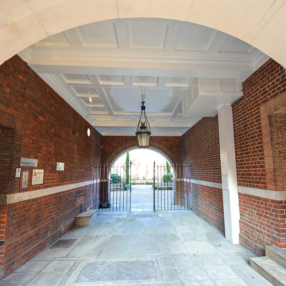 University-passageway-arch with stonework and fresh painted and decorated roofing