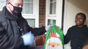 Peabody Toy Appeal - Axis operative handing over gifts to resident