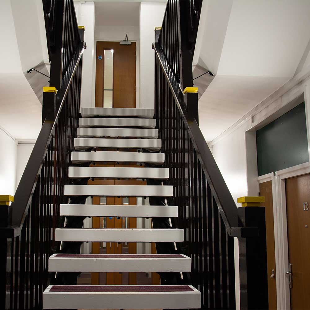 Newly decorated interior staircase with black painted bannister