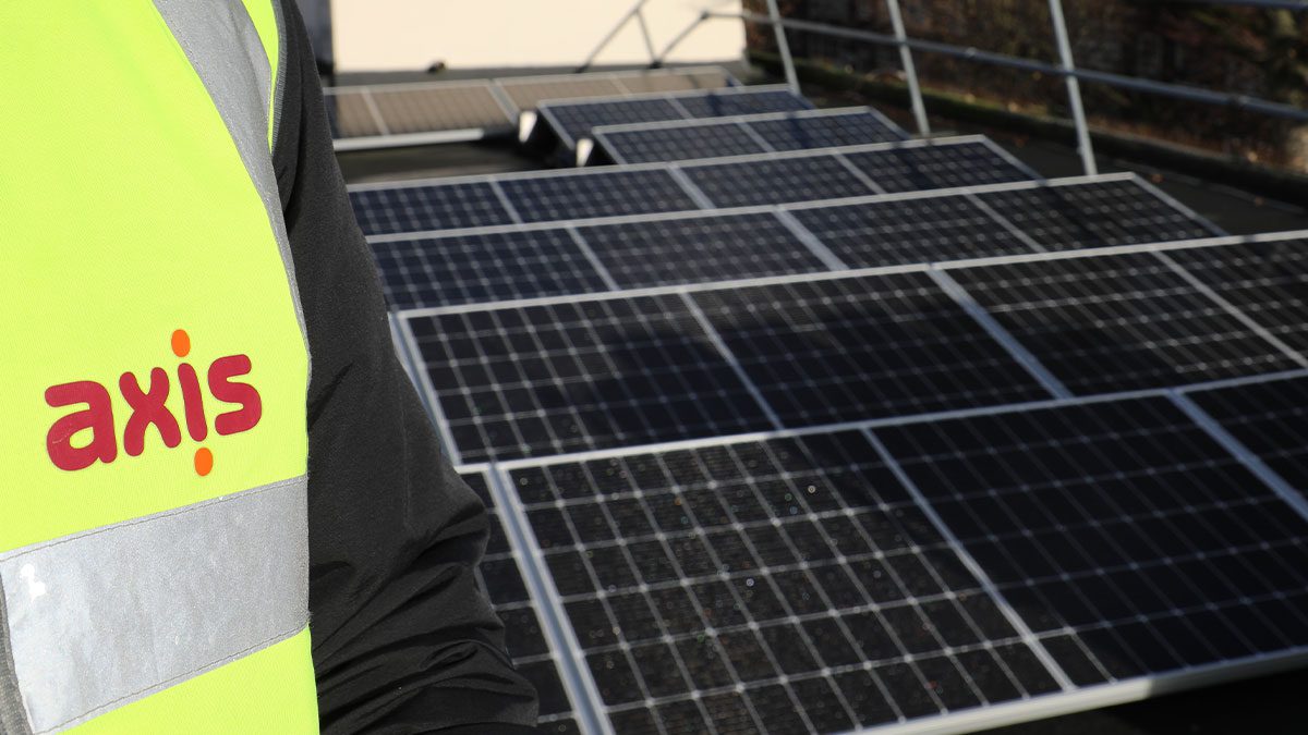 Solar panels next to axis branded high-vis vest