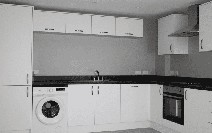 White kitchen with dark grey counter top
