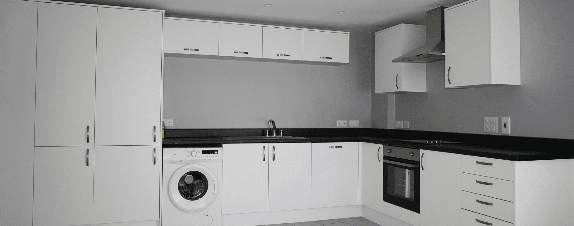 White kitchen with dark grey counter top