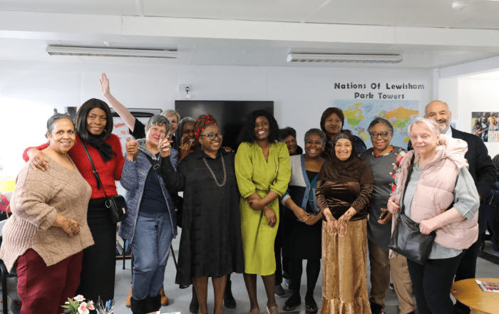 Group photo of women in colourful clothing in a room.
