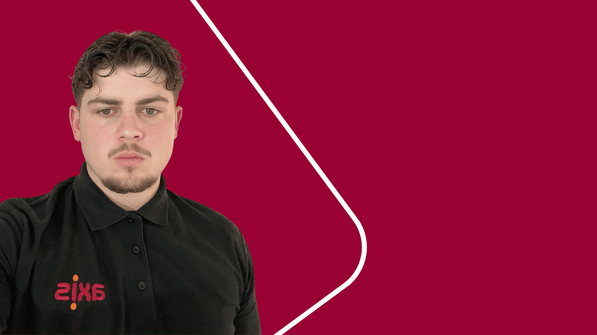 Boy wearing black Axis shirt with a red background