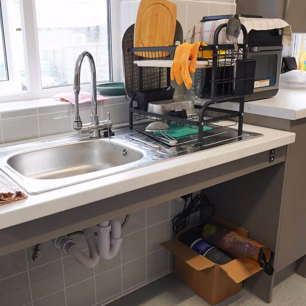 A close-up of an accessible kitchen sink with open space underneath, allowing a resident in a wheelchair to comfortably use the facilities.