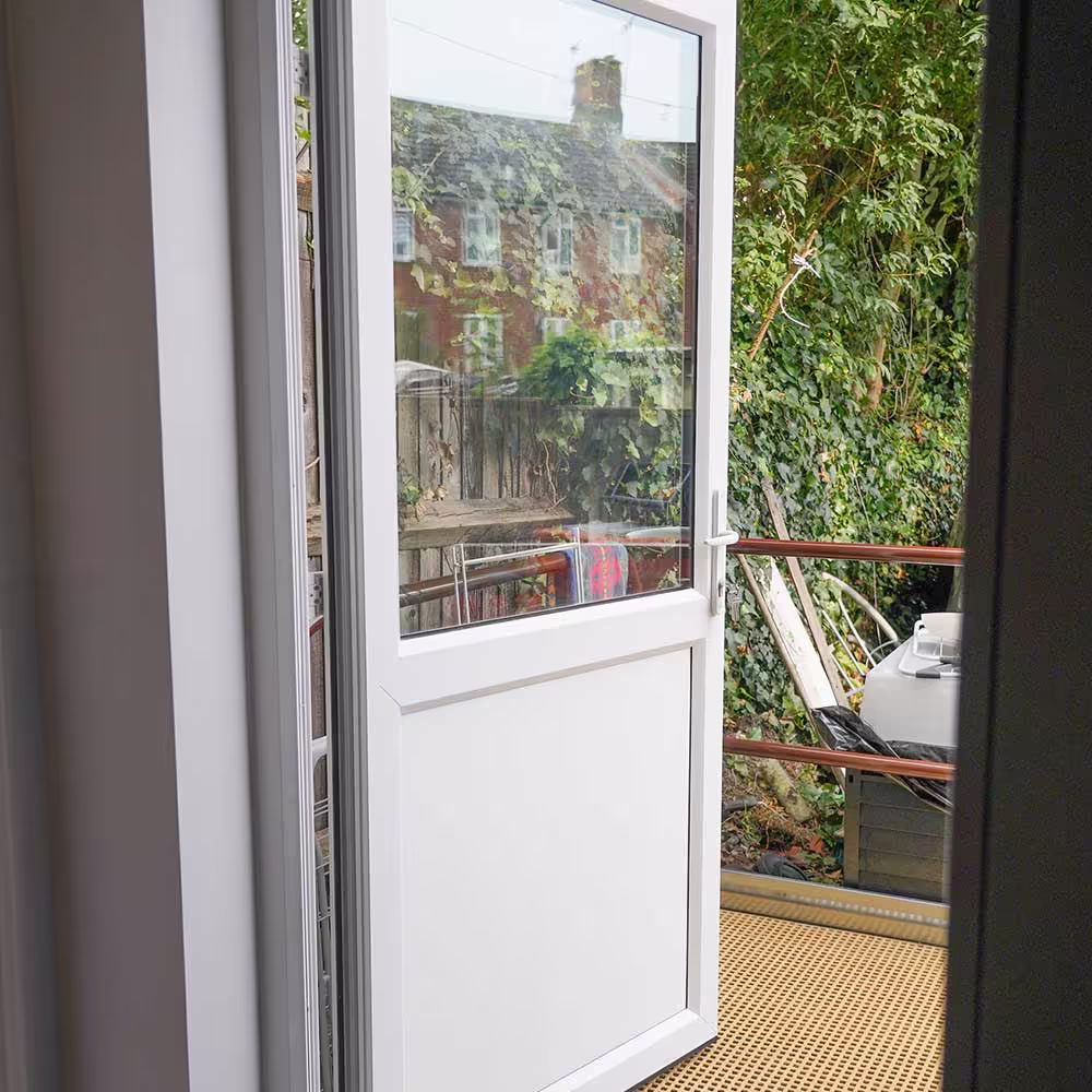 A new, low-threshold back door opens onto a ramp, providing seamless and safe access to the garden for a wheelchair user.