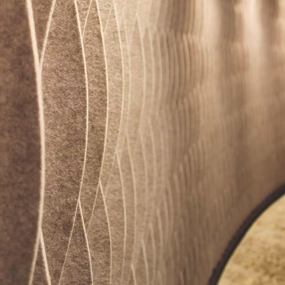 A close-up detail of the textured acoustic wall panels in the refurbished reception, showing the soft, undulating wave pattern of the material.