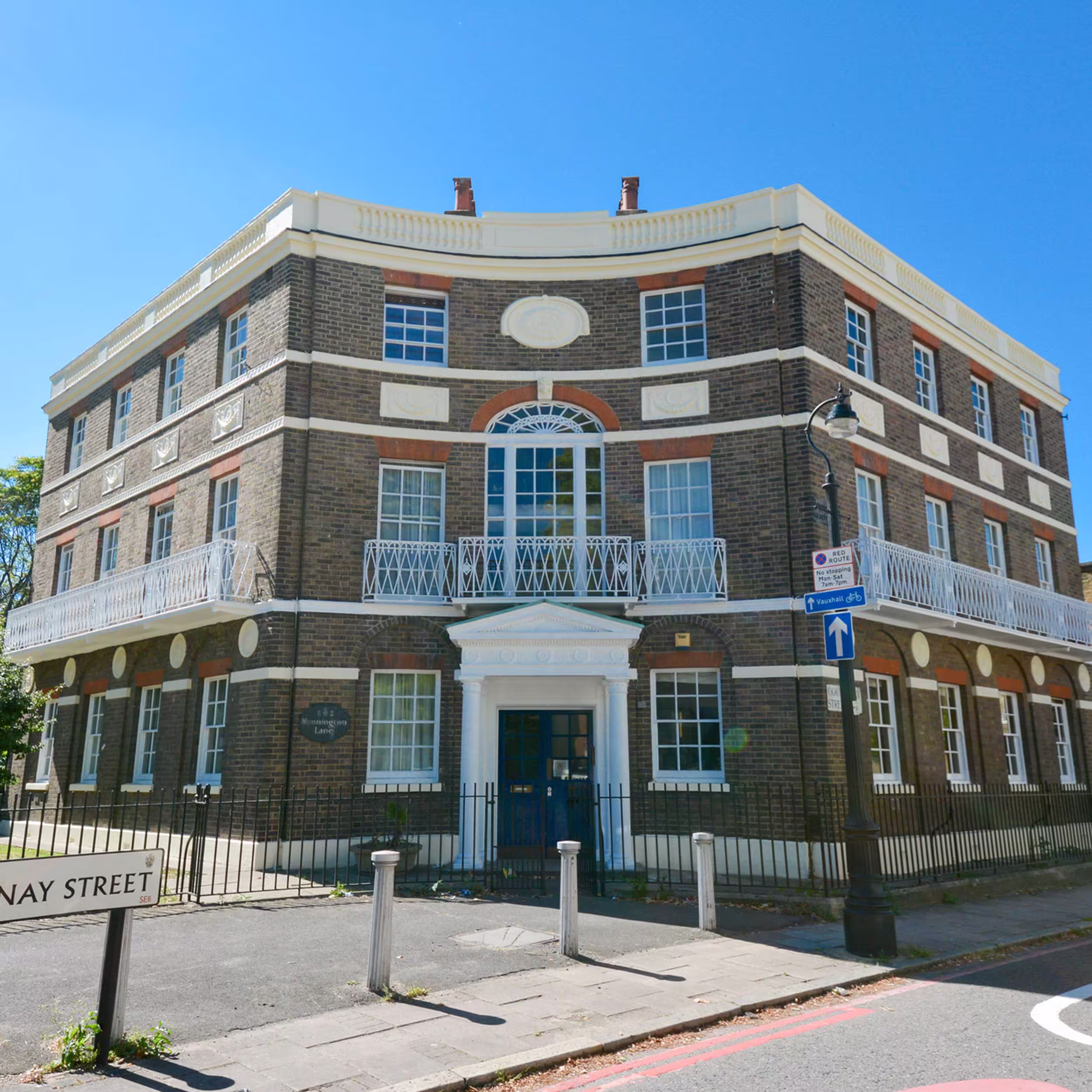 The impressive curved facade of a historic Georgian building on a London street corner, expertly maintained as part of a cyclical decorations contract.