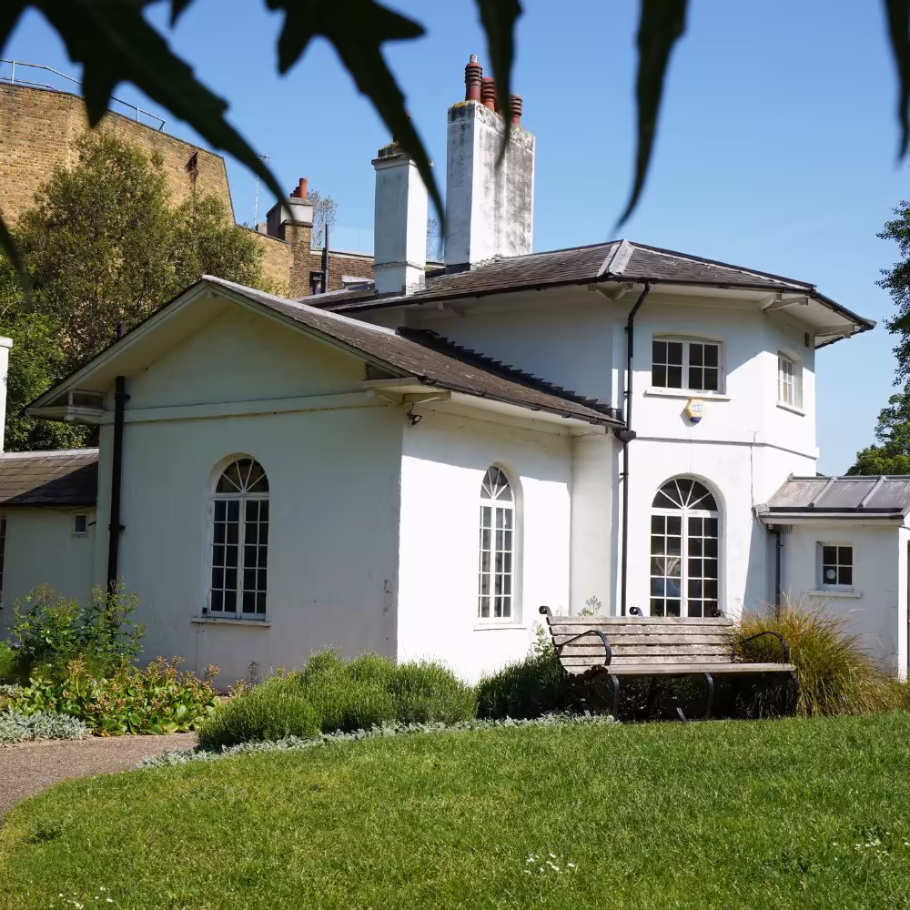 The pristine, white Grade II listed property viewed from its garden on a sunny day after the completion of its full refurbishment.