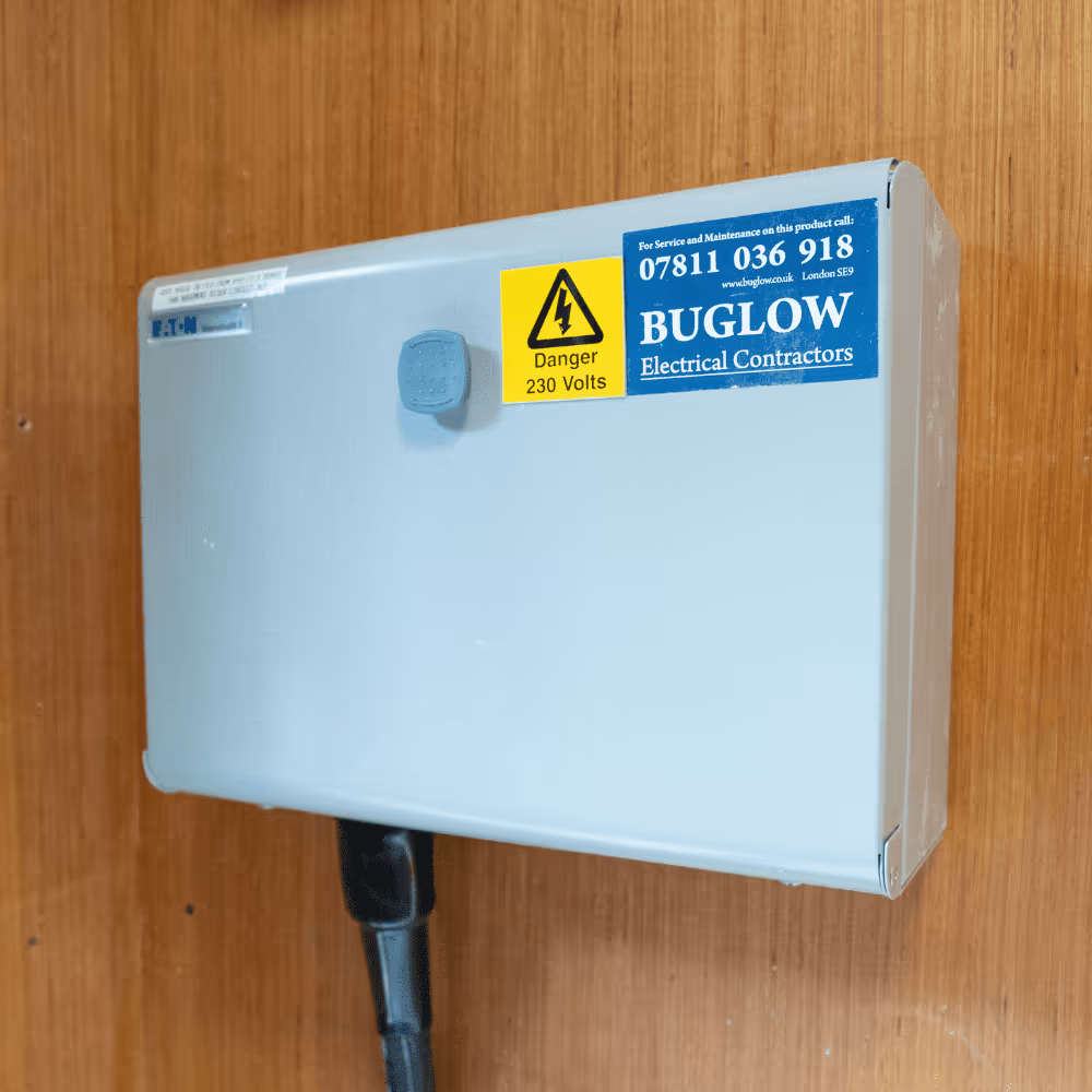 A close-up of a newly installed electrical control box on a wood-panelled wall, part of the modernisation and conversion of the heritage building.