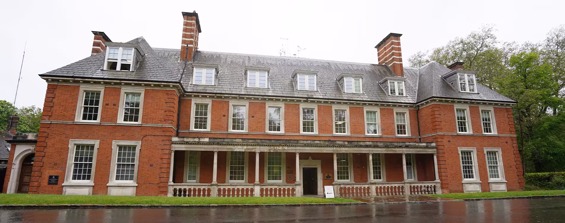 The grand, red-brick exterior of a large heritage building, home to The Royal Parks and Metropolitan Police in Hyde Park, after a sensitive refurbishment and modernisation project.