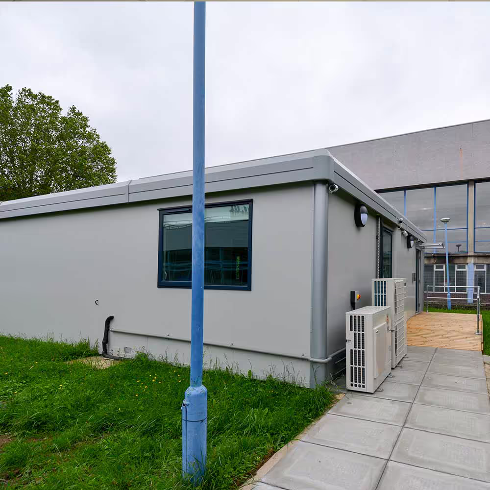 Worker connecting electrical and structural components between modular sections for alignment.