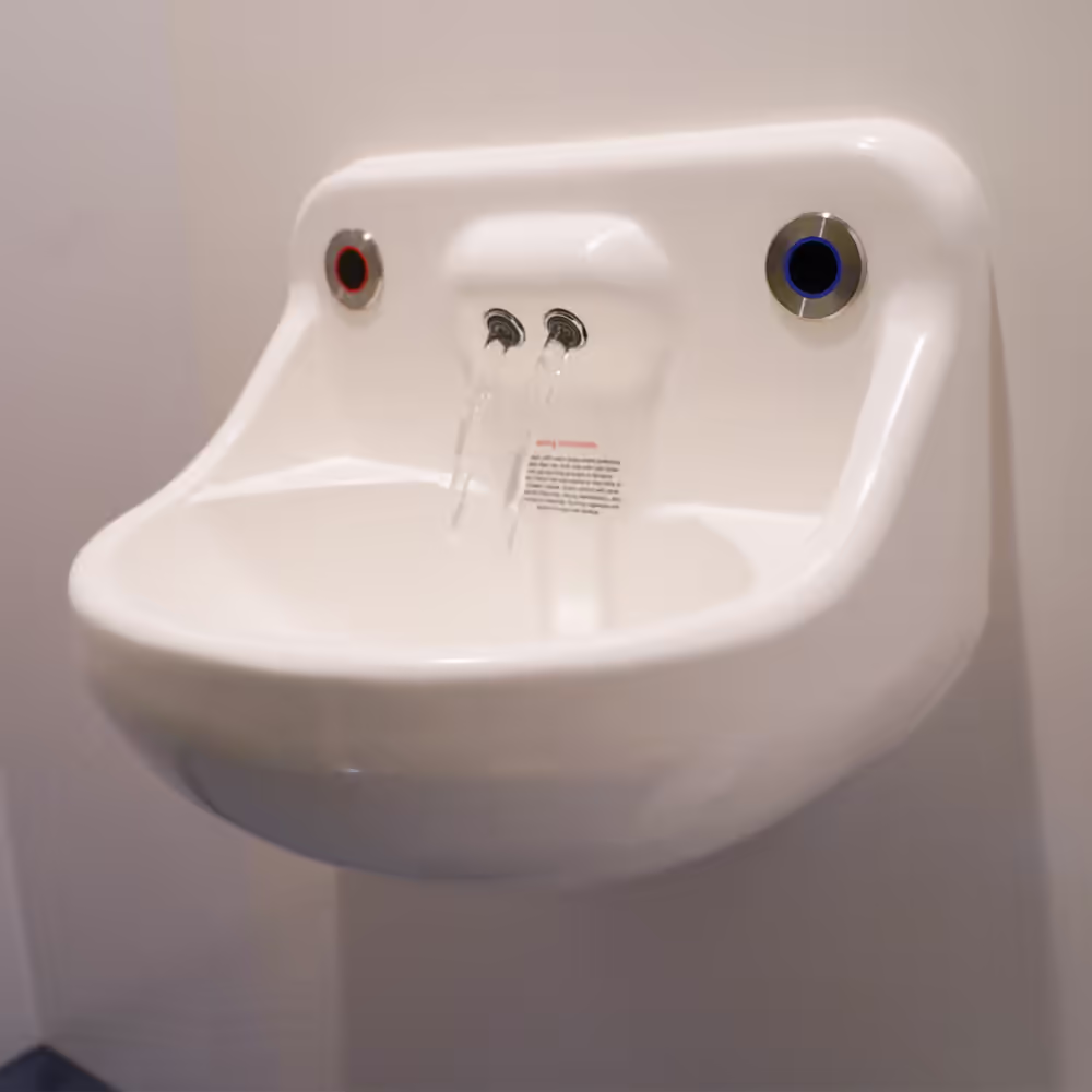 Refurbished NHS corridor with new lighting, flooring, and accessibility improvements.