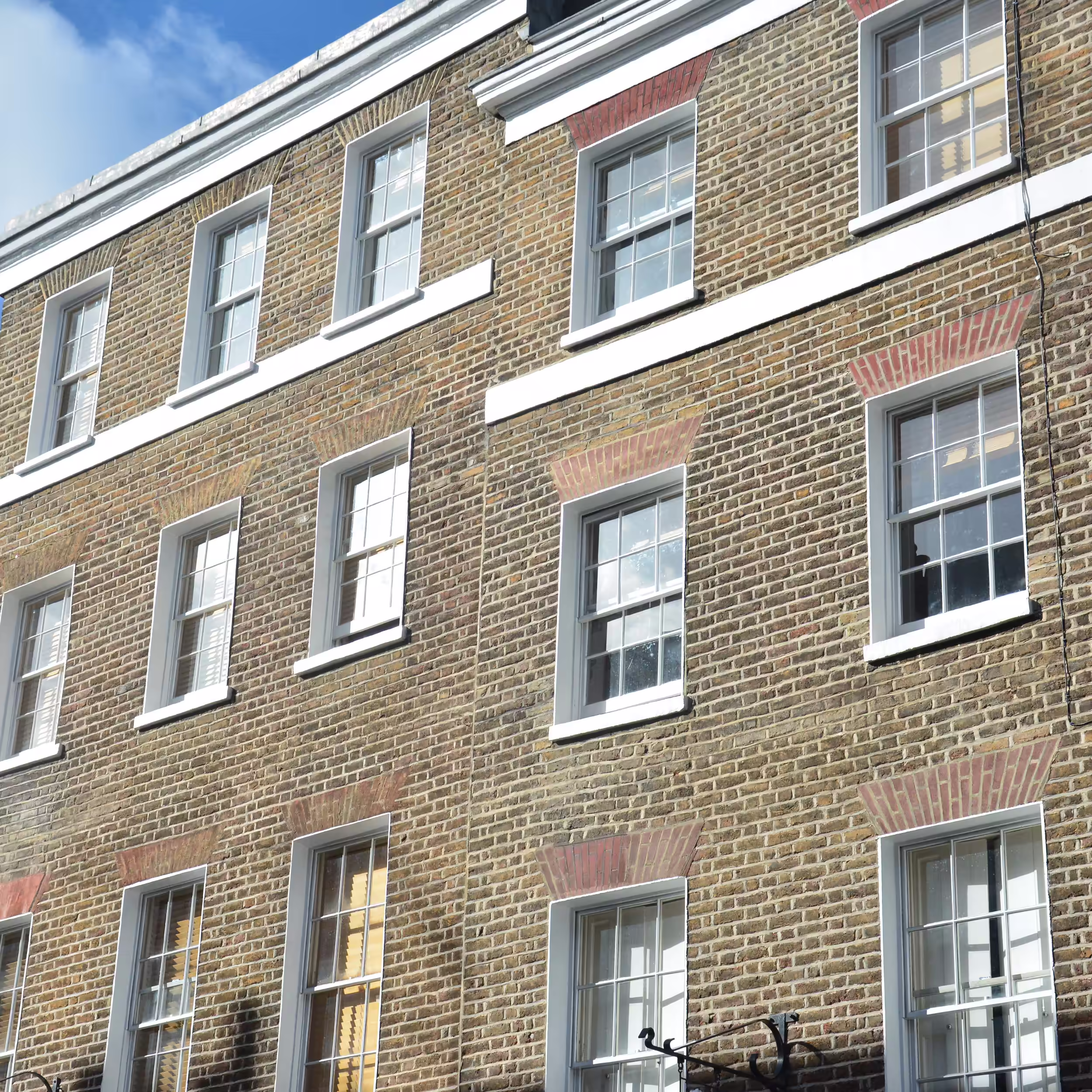 Stone masonry specialist restoring heritage façade of a listed period property.