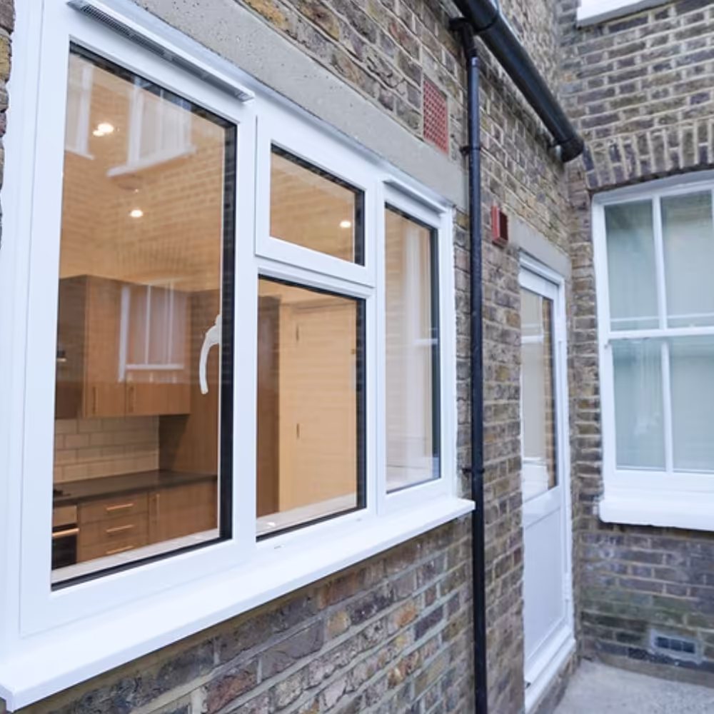 Workers installing wall insulation as part of a housing retrofit and refurbishment project.