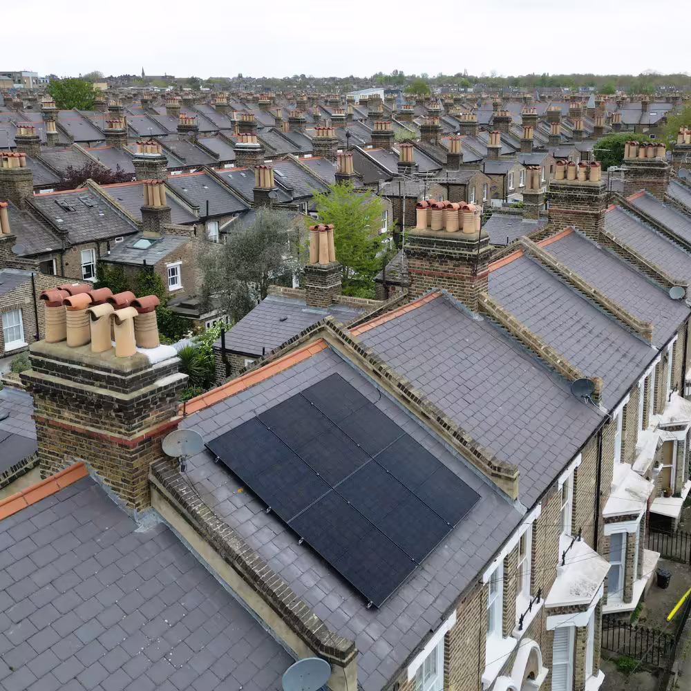Engineer testing ventilation and heat recovery systems in an upgraded residential property.