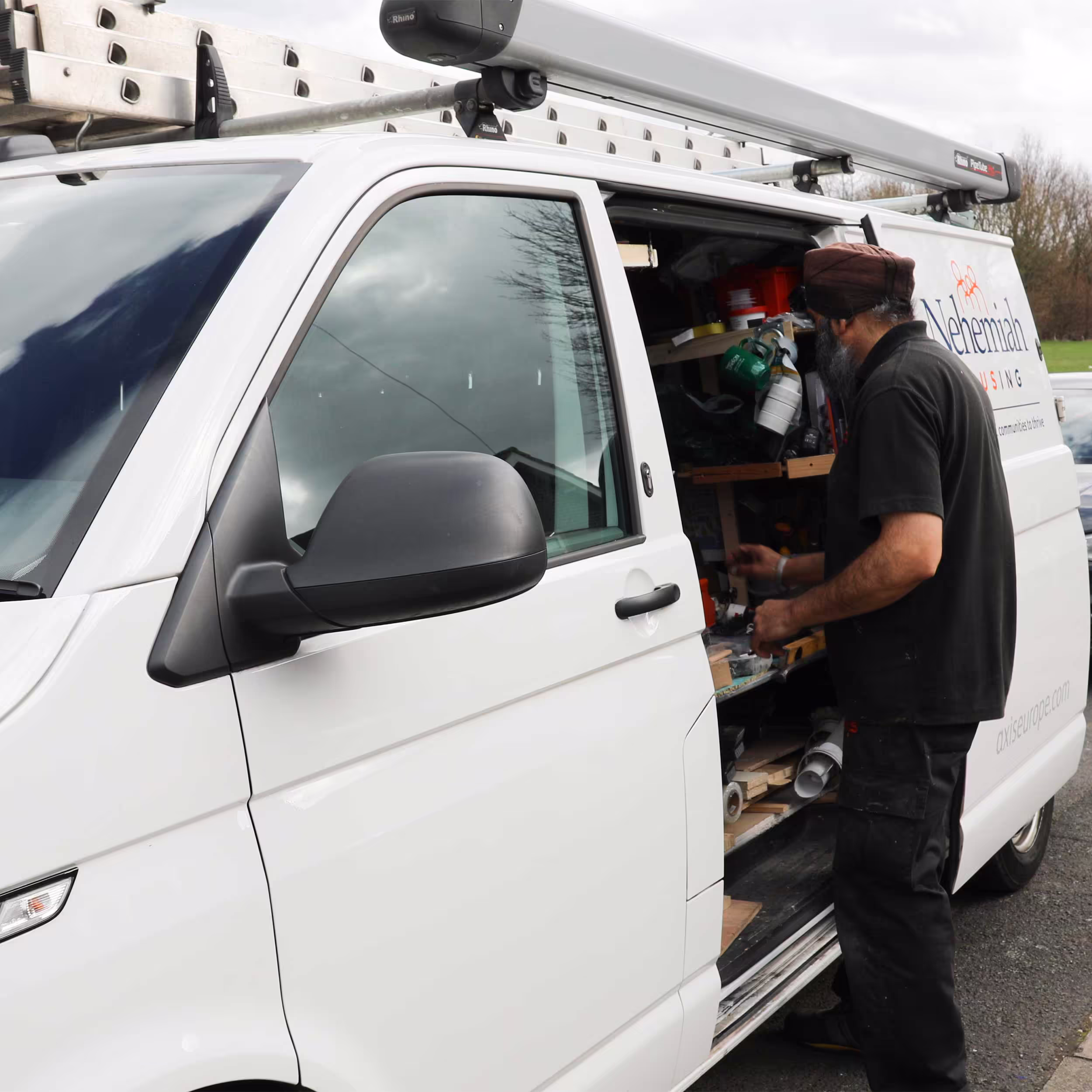 An Axis operative for the Nehemiah Housing contract retrieves tools and materials from the well-organised racking inside his service van.
