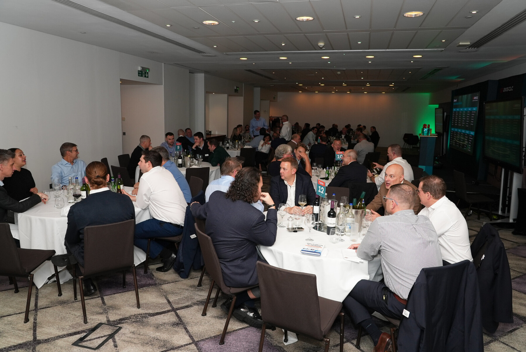 Tables of people in a dark room