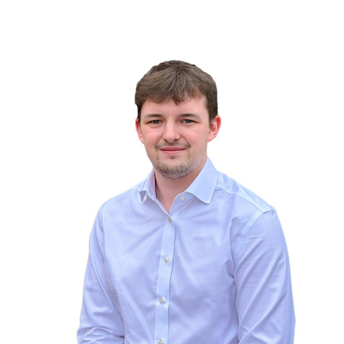 Smiling boy in a blue shirt with a white background