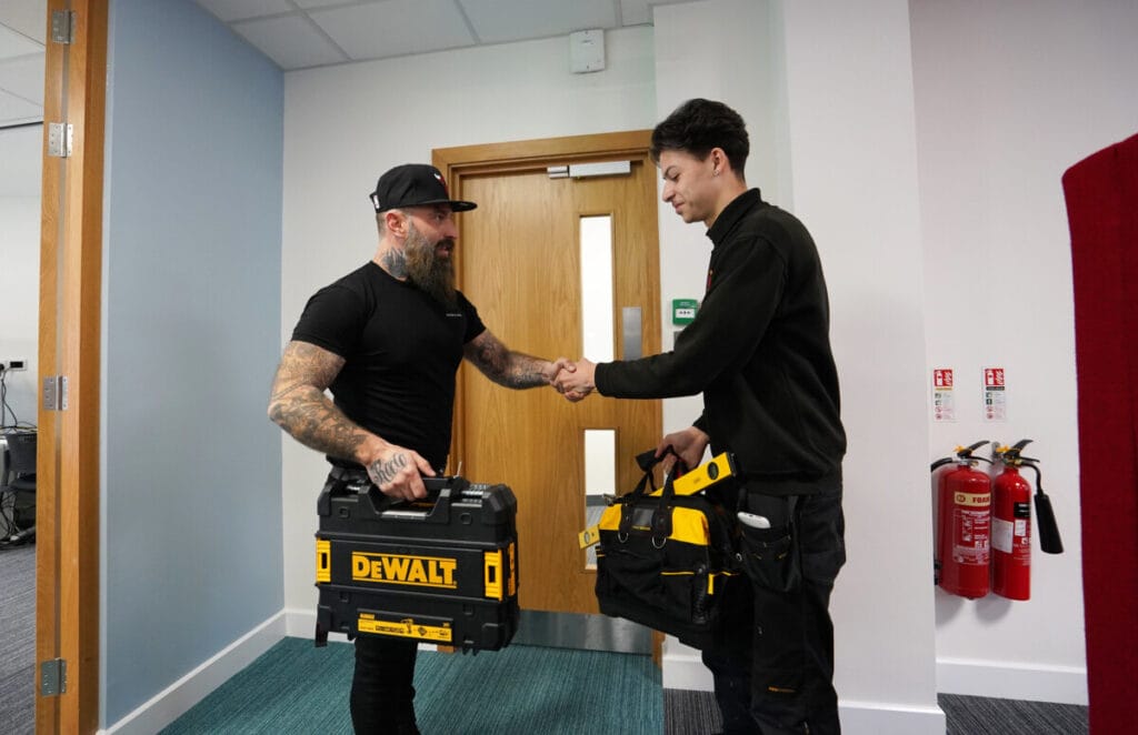 Two Axis employees shaking hands.