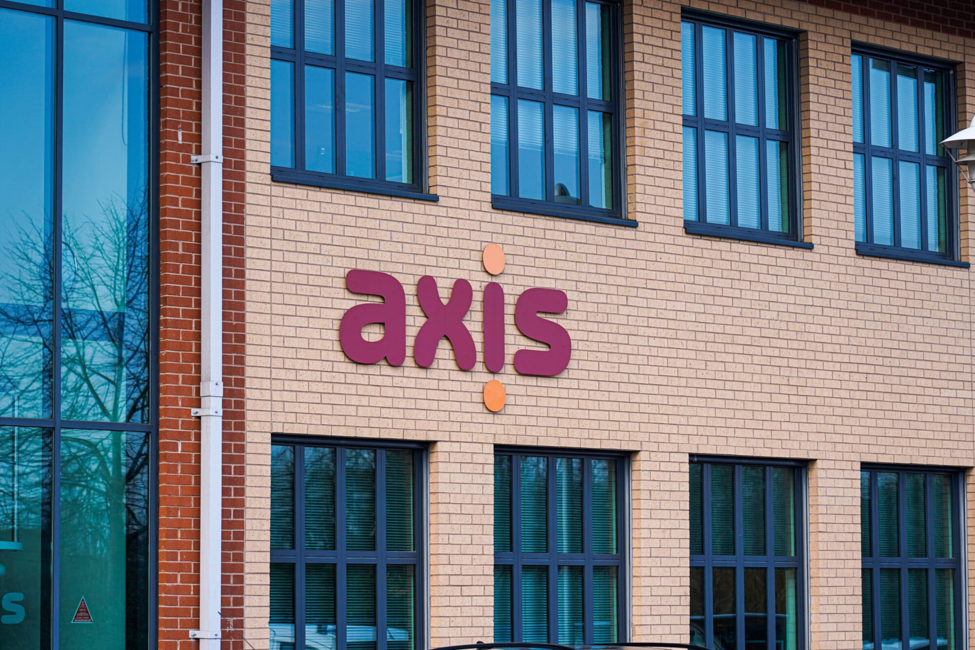 Axis office building with logo in red and orange.