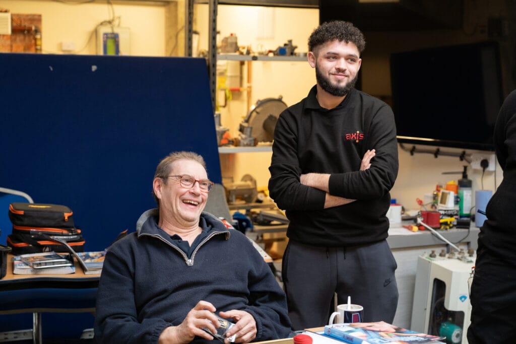 An Axis apprentice with an operative.